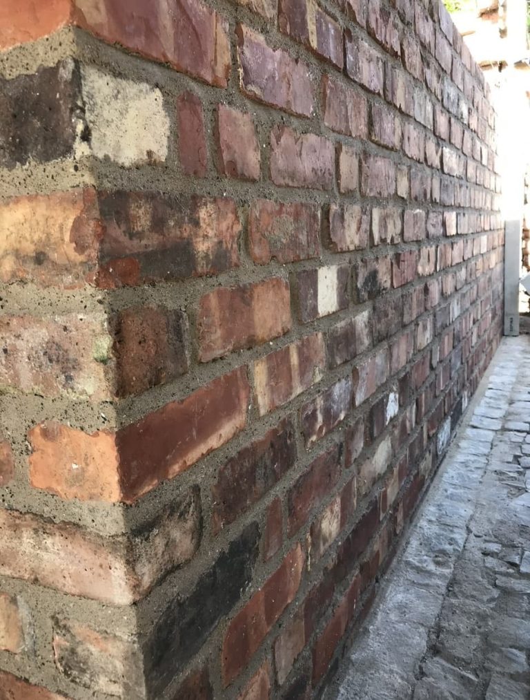 Traditional brick boundary wall built in Aigburth, Liverpool using Lime mortar