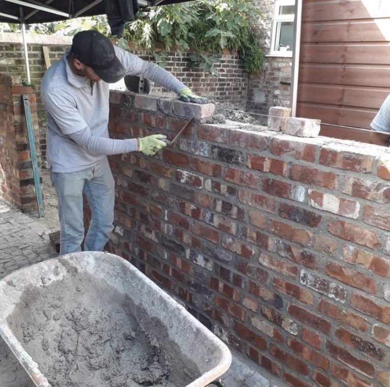 Bricklayer in Aigburth rebuilding a boundary wall